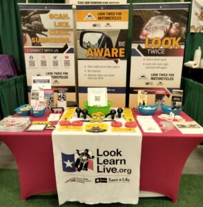 Look Learn Live booth at the Rio Grande Valley Home and Garden Show with materials on the table. 
