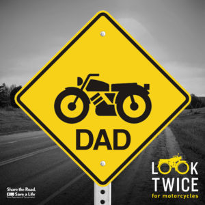 Image of a warning sign with "Look Twice: Dad" and motorcycle icon