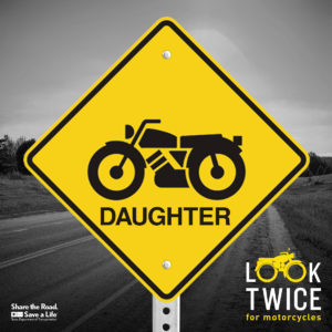 Image of a warning sign with "Look Twice: Daughter" and motorcycle icon