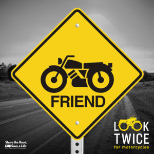 Image of a warning sign with "Look Twice: Friend" and motorcycle icon
