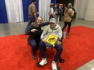 Look Learn Live's Michelle Canton poses for a picture with a motorcycle rider, who happens to be a veteran.