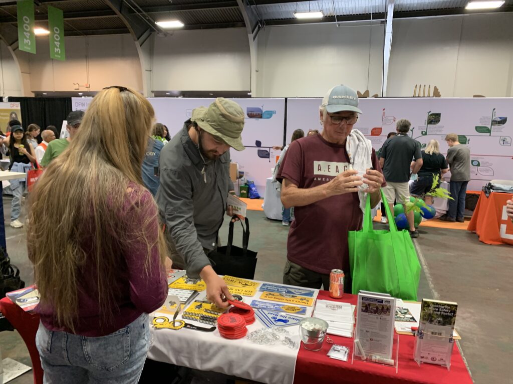 Attendees of EarthX stop by the Look Learn Live booth to pick up some motorcycle safety swag and tips.