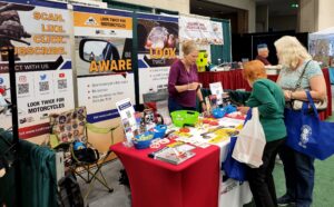 Look Learn Live booth featuring guests and Look Learn Live researcher Cathy Brooks behind the table.